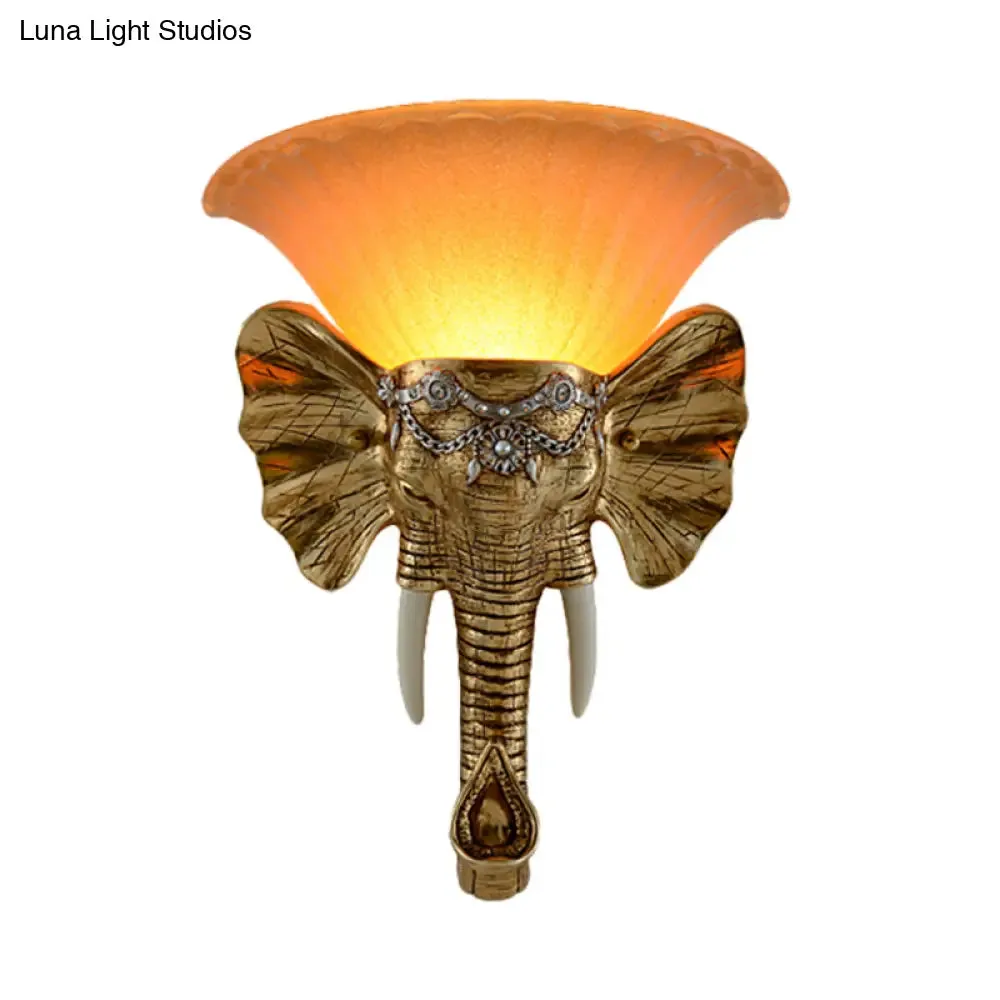 Modern Amber Glass Sconce with Gold Elephant Accent